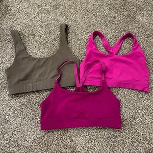 Three sports bras: Athleta and Ptula